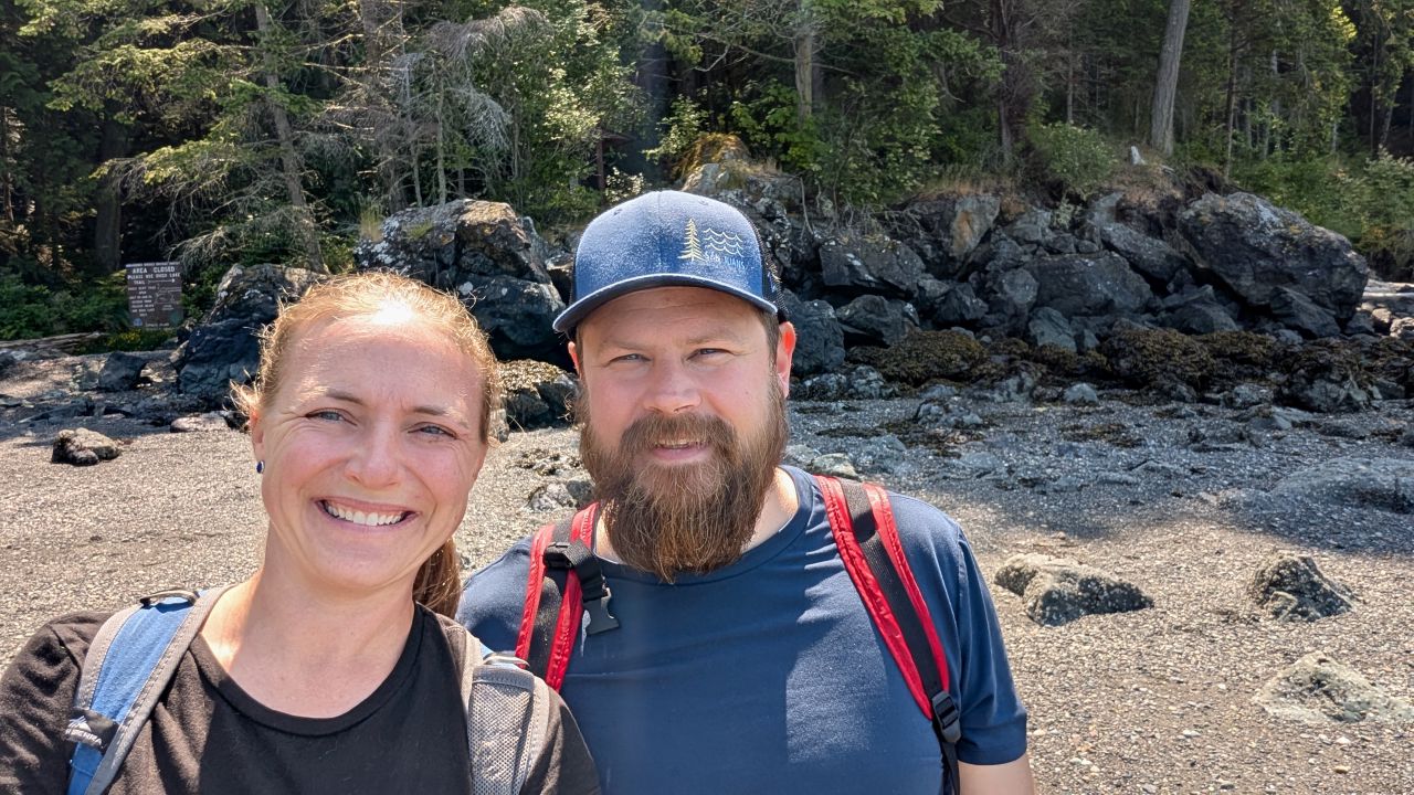 Rachel and Brian selfie on the beach at Smuggler’s Cove on Cypress Island