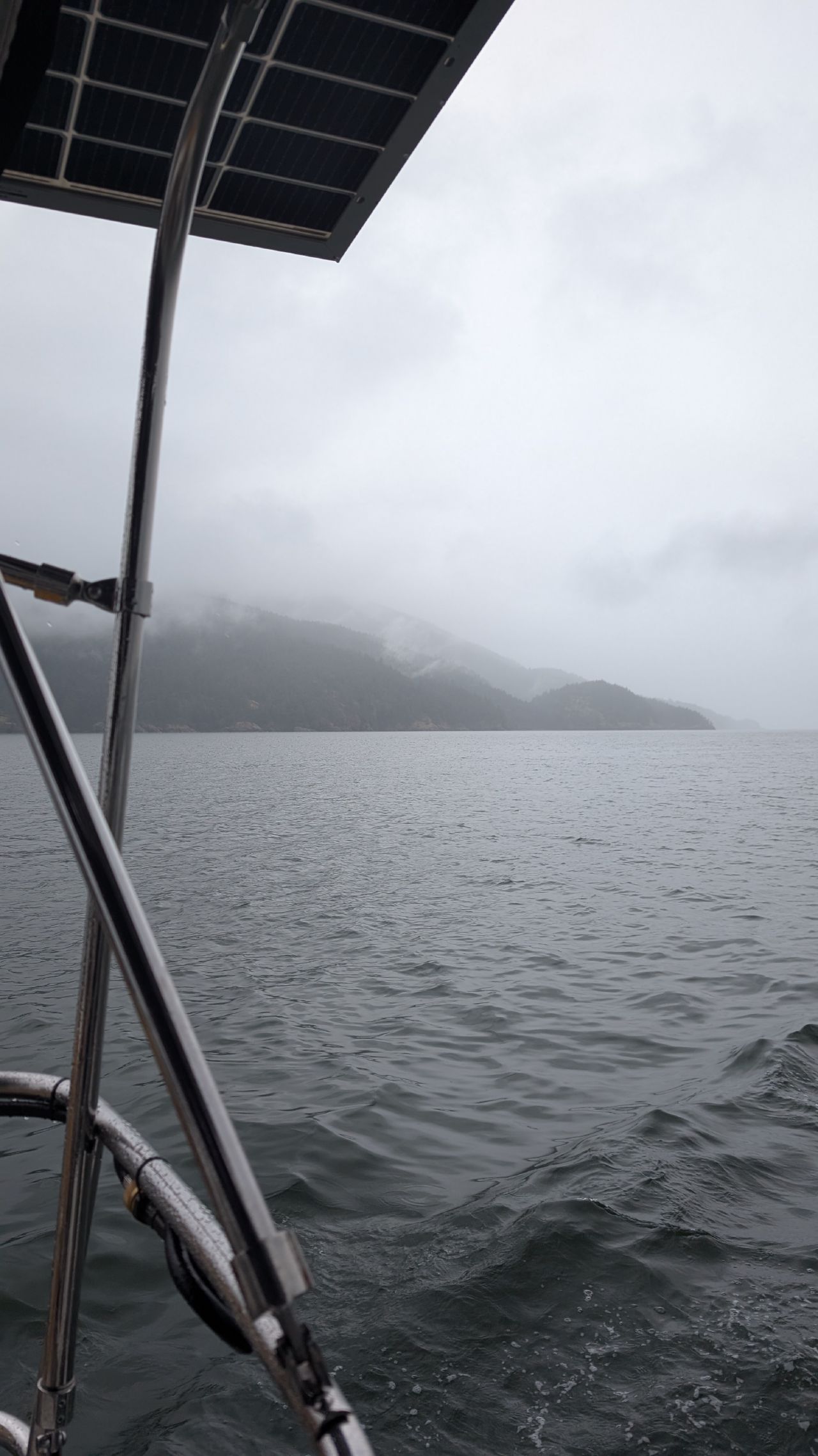 Overcast view of foggy mountains from the sailboat on the passage to Sucia Island
