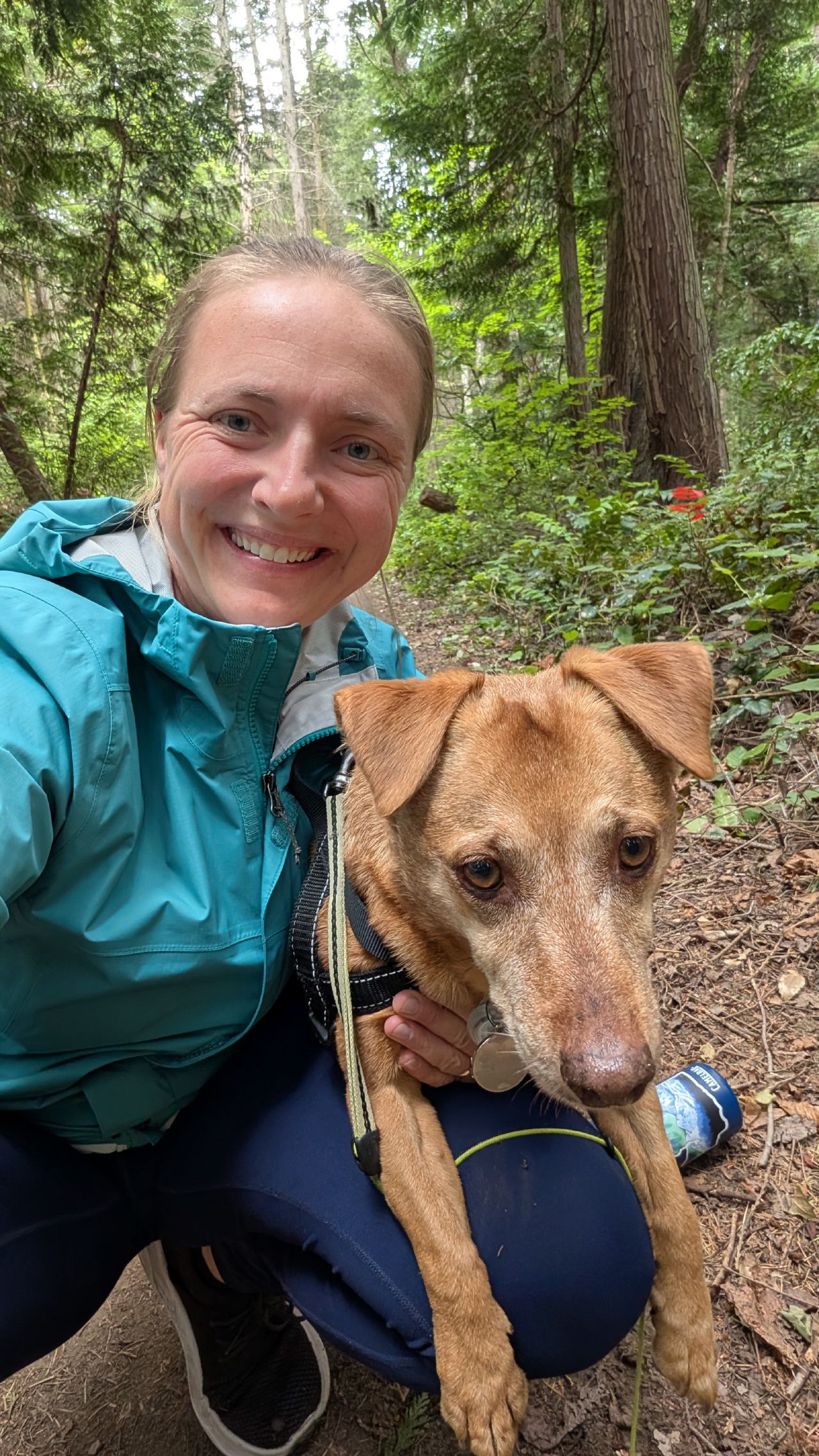 Rachel and Maui on a hiking trail through the lush green forest on Sucia Island