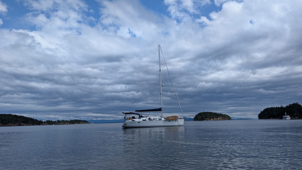 SV Yahara at anchor near Sucia Island with dramatic clouds overhead