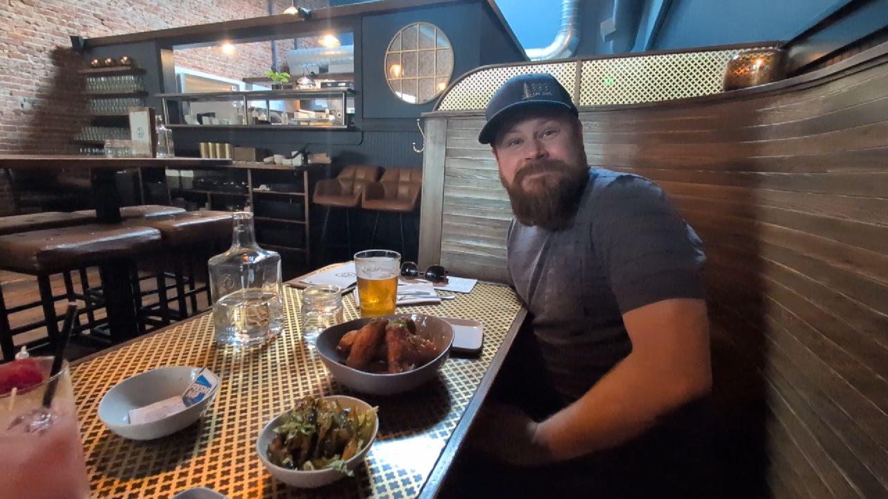Brian enjoying birthday dinner with beer and wings at a restaurant in Bellingham