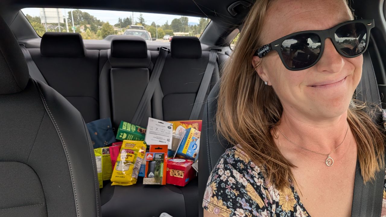Rachel running errands in the rental car with groceries and supplies in the back seat