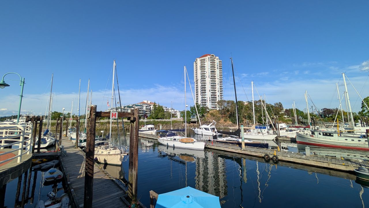 Nanaimo Harbour marina with boats and waterfront highrise on a sunny day