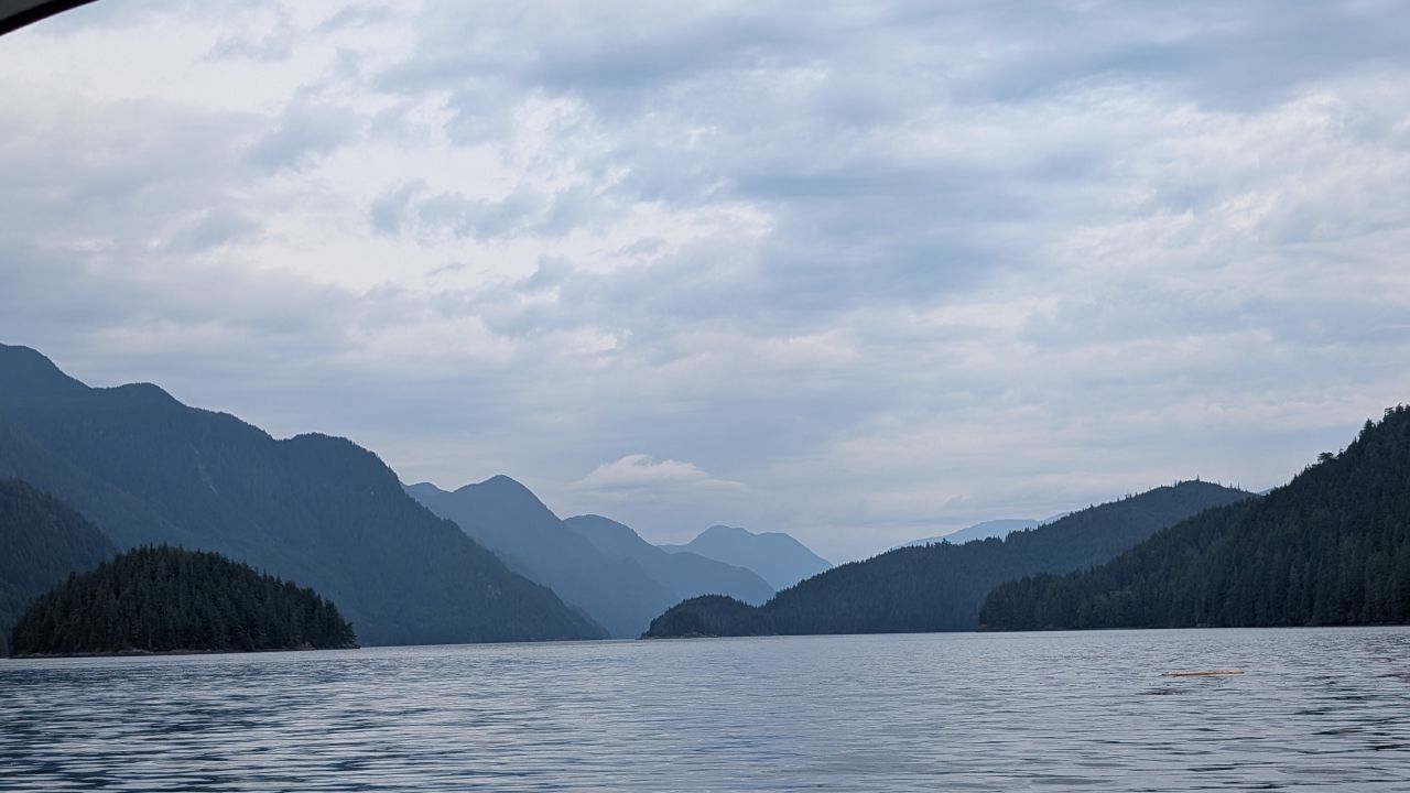 Layered misty mountains viewed from the water in Chatham Channel