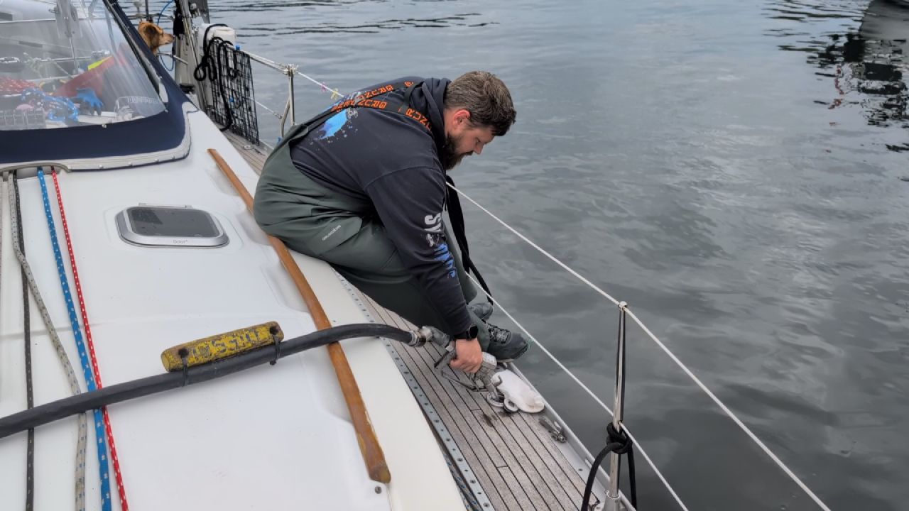 Brian connecting the fuel hose on the deck of SV Yahara at Lagoon Cove Marina