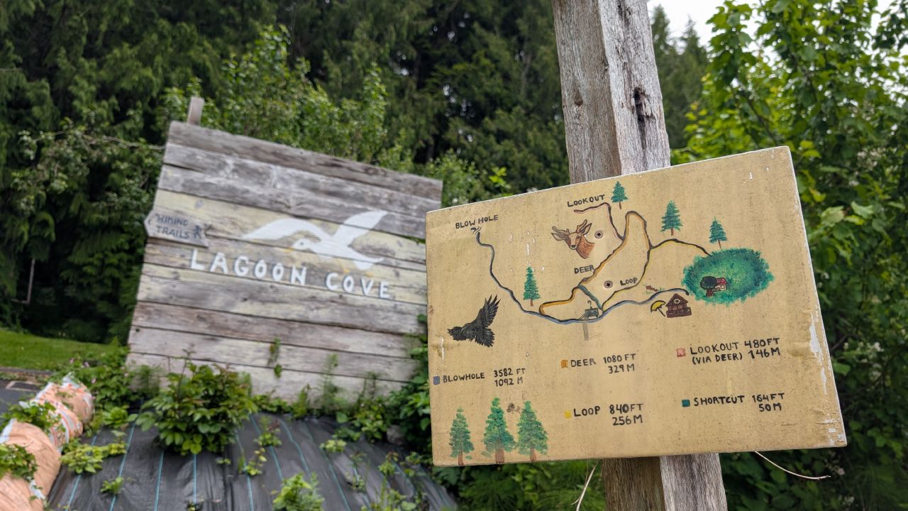 Lagoon Cove hiking trails sign with a hand-painted map of the trail system