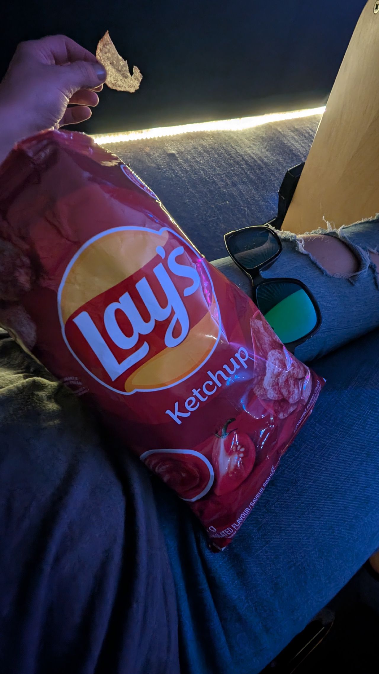 Enjoying a bag of Canadian ketchup chips at the concert