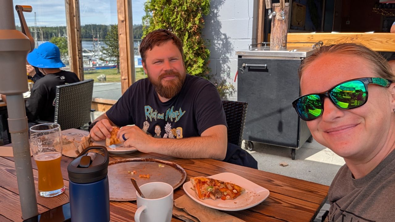 Brian and Rachel eating pizza and drinking beer at the local brewery in Port McNeill