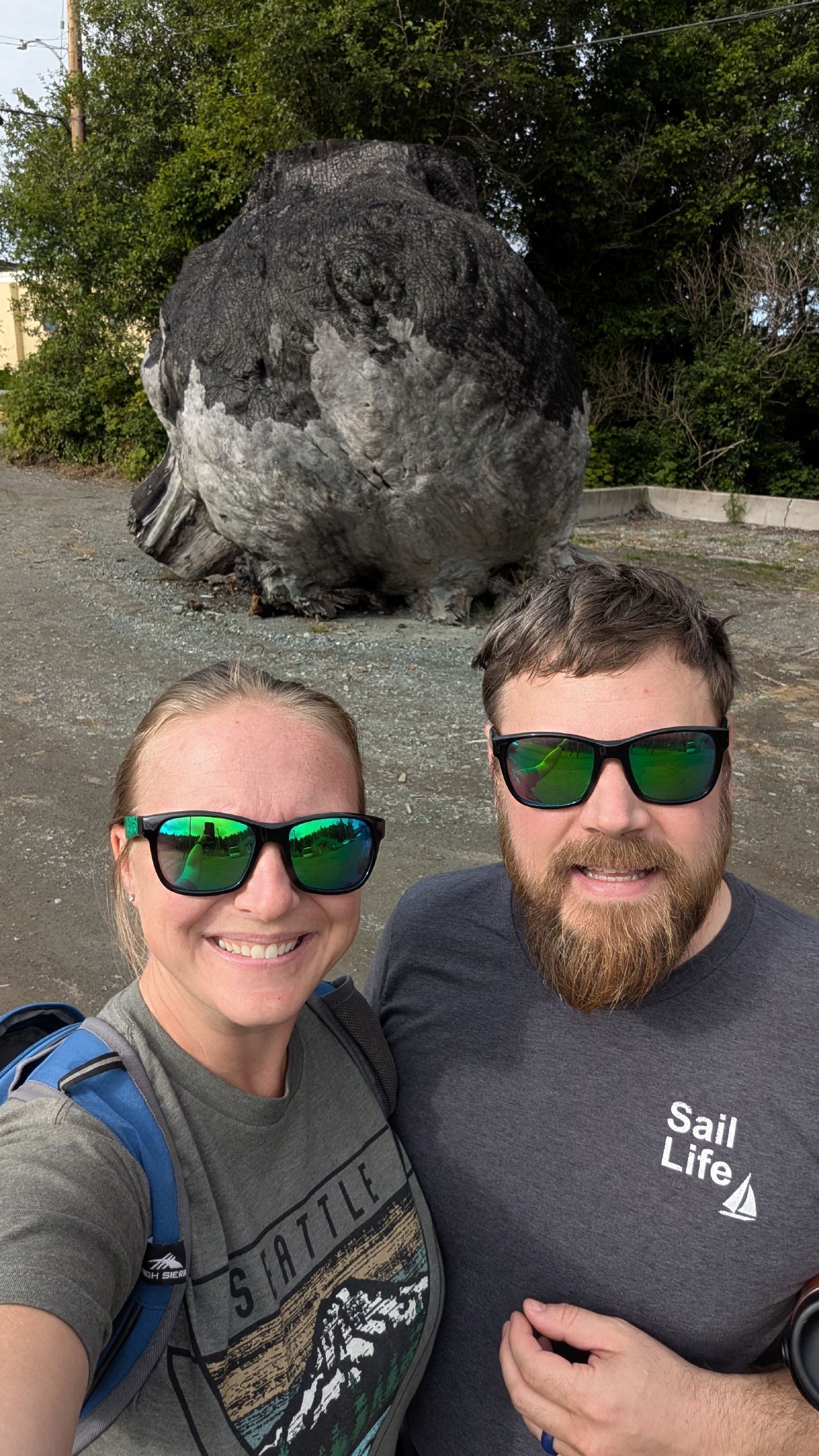 Rachel and Brian selfie in front of a giant burl in Port McNeill