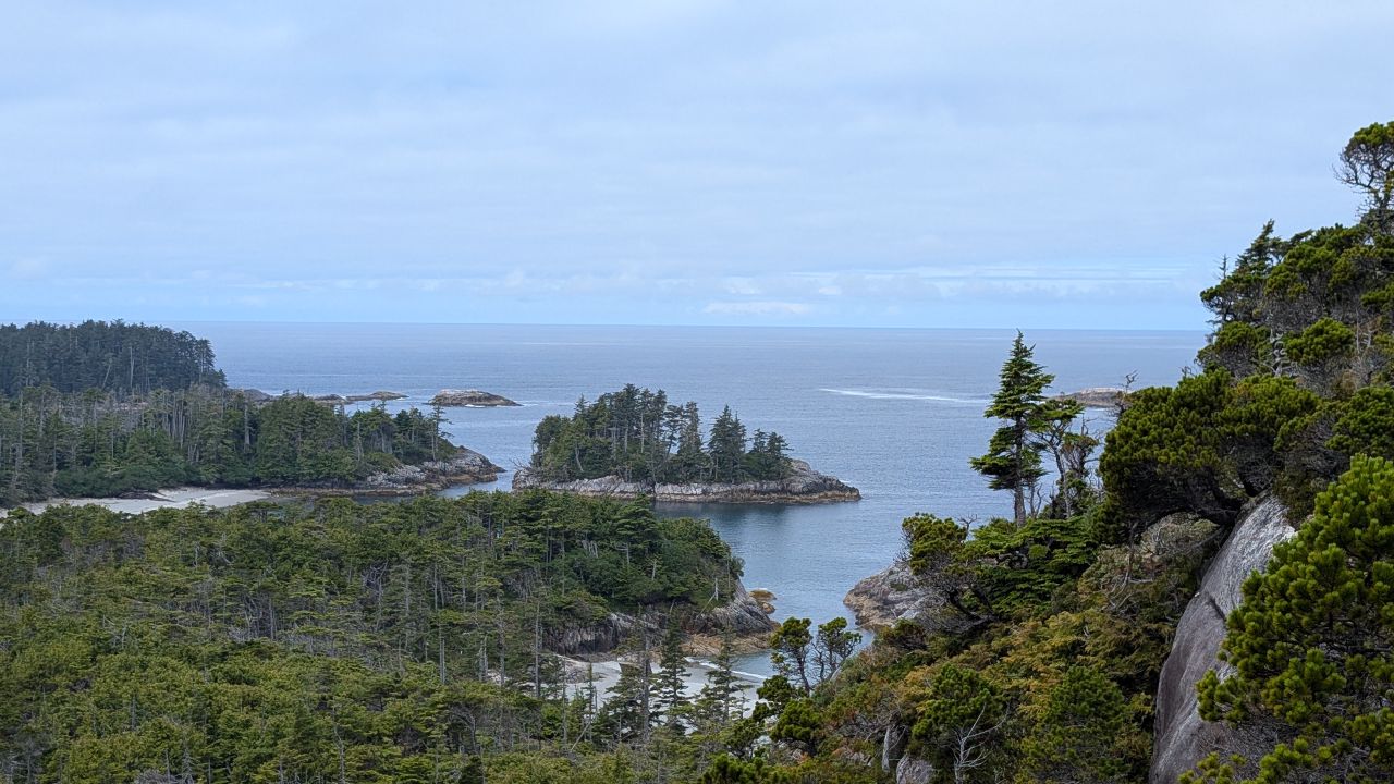 Panoramic viewpoint of forested islands and open ocean from the hiking trail near Pruth Bay