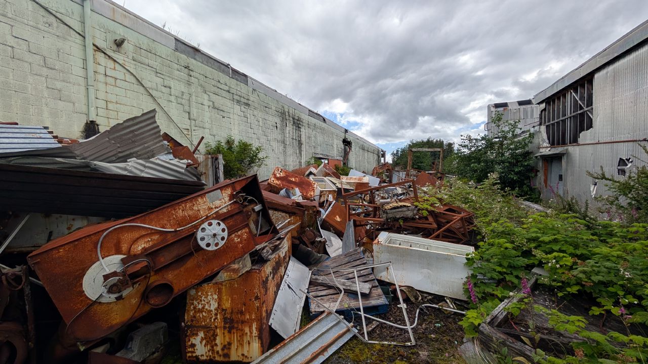 Pile of rusty machinery and industrial debris outside the abandoned Namu cannery