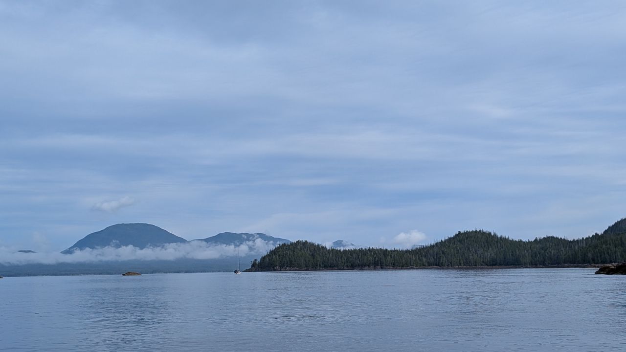 Calm water with misty mountains and low clouds on the passage to Codville Lagoon