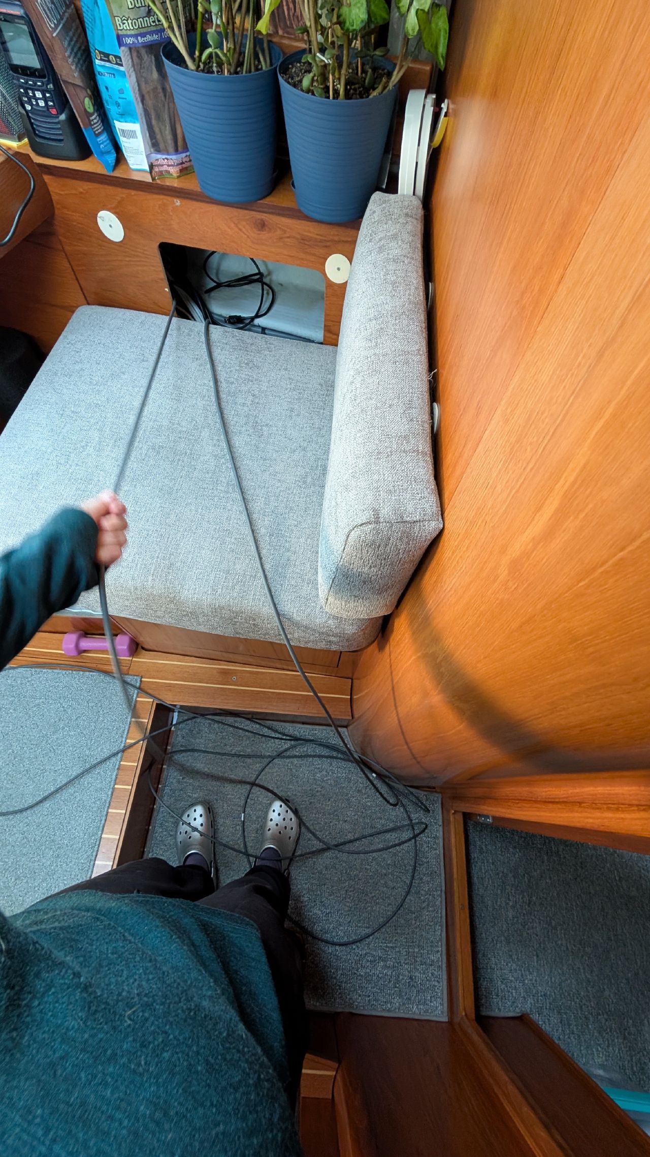 Running a new Starlink cable through the boat interior behind the settee cushions