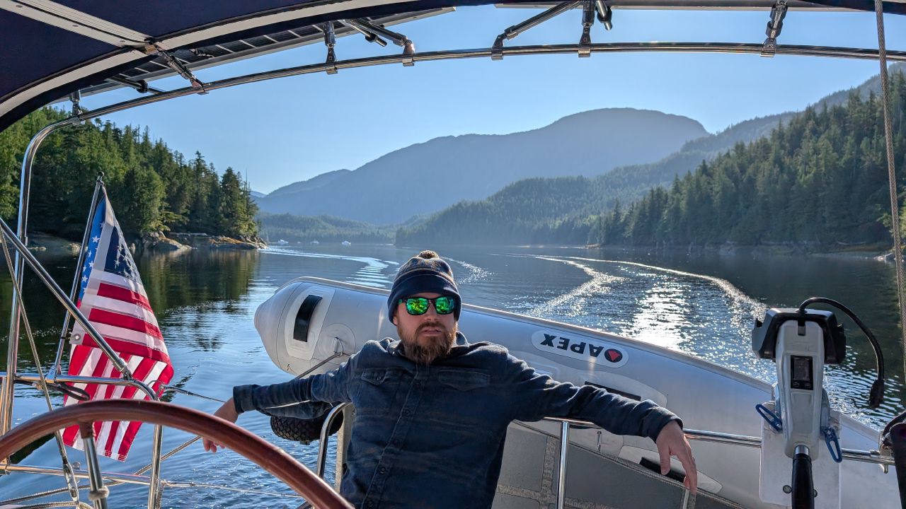 Brian at the helm entering the breathtaking inlet to Ocean Falls on a sunny day