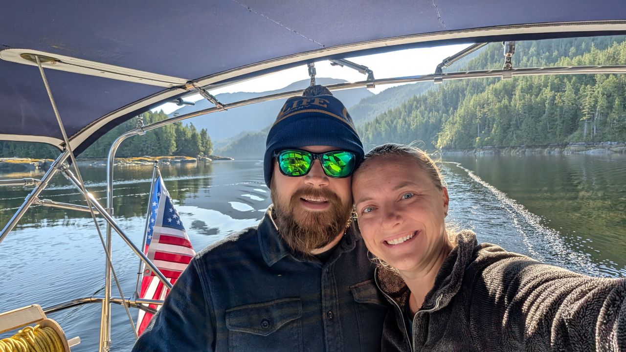 Rachel and Brian selfie in the cockpit on a beautiful sunny day underway