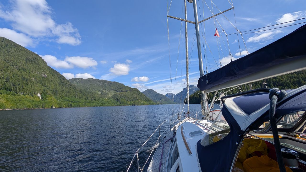 Sailing through the stunning green mountain inlet approaching Ocean Falls