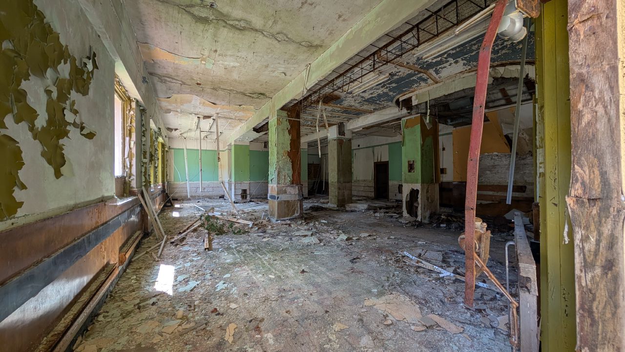 Inside the abandoned hotel at Ocean Falls with crumbling walls and debris on the floor
