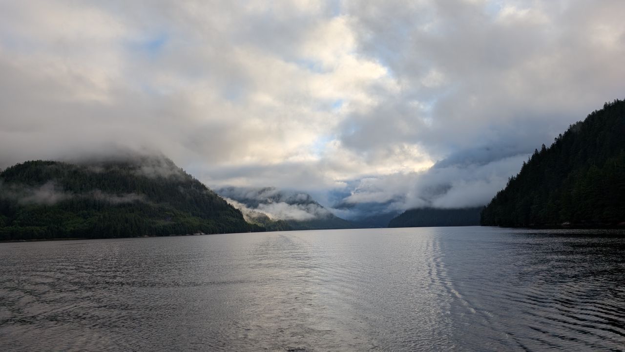Dramatic clouds breaking over the forested mountains on the inlet passage to Shearwater