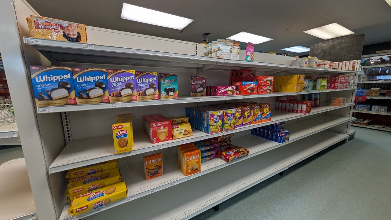 Sparsely stocked grocery store shelves with Canadian snacks at the Shearwater store