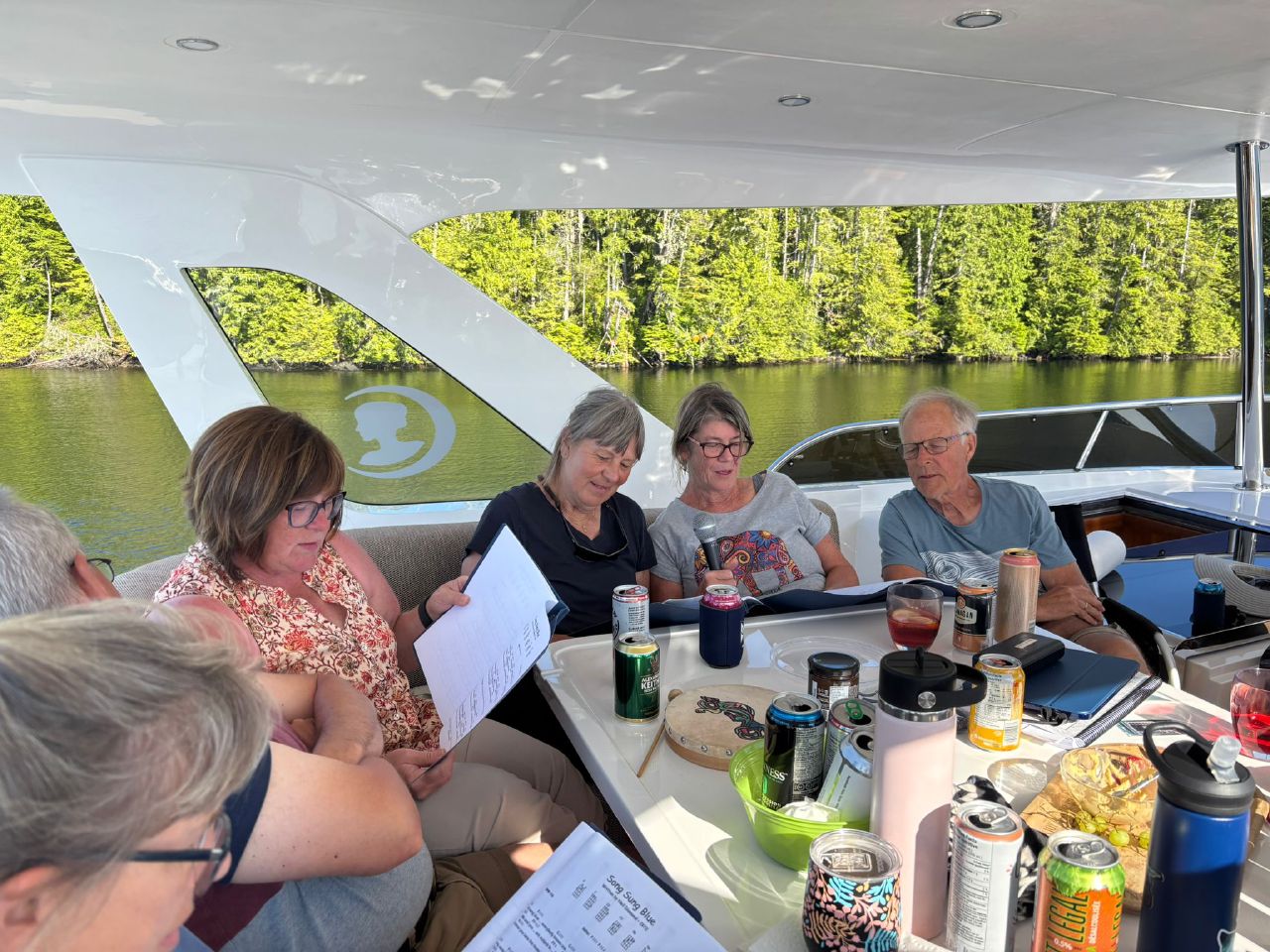 Flotilla friends gathered in the cockpit of Grato for appy hour and singing in Oliver Cove