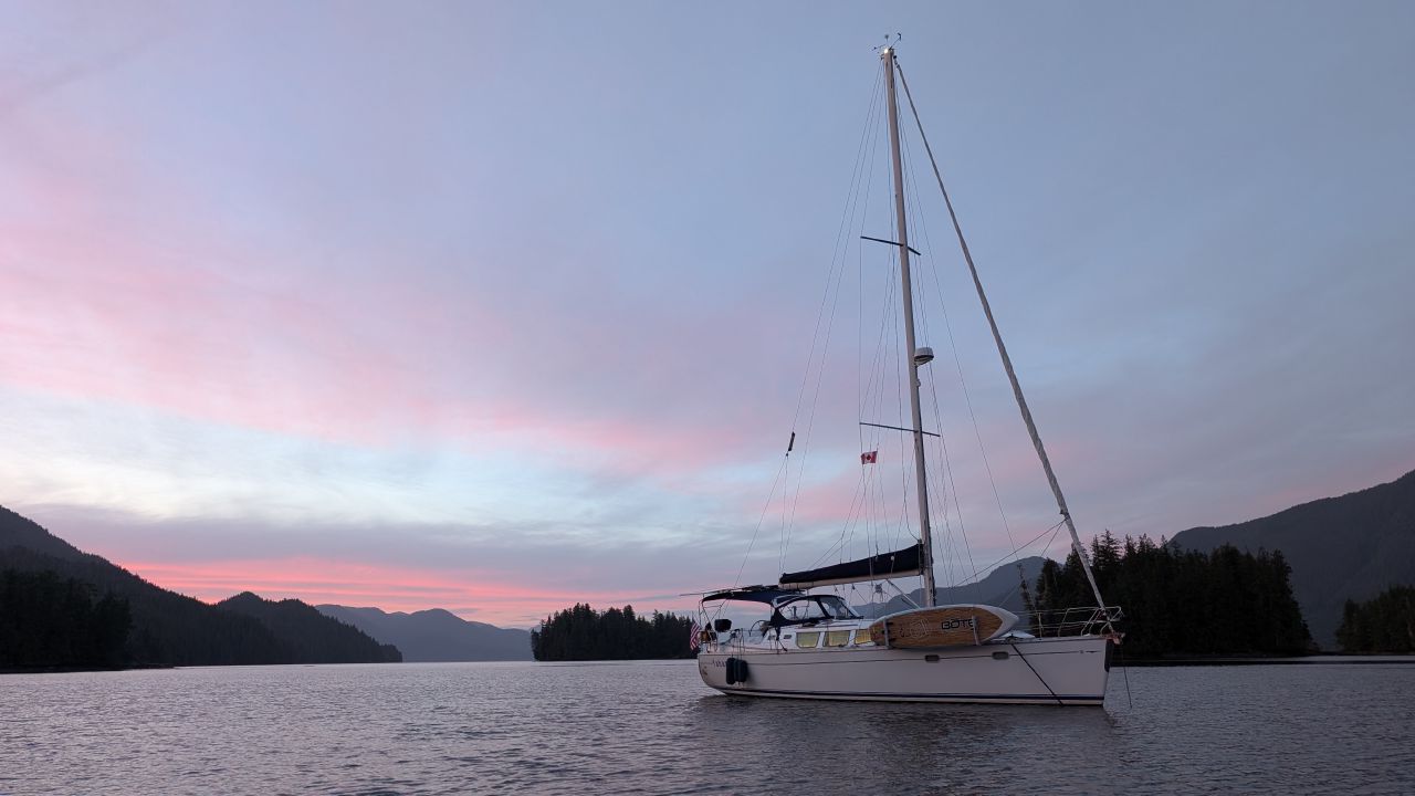 SV Yahara at anchor in Rescue Bay under a gorgeous pink and purple sunset sky