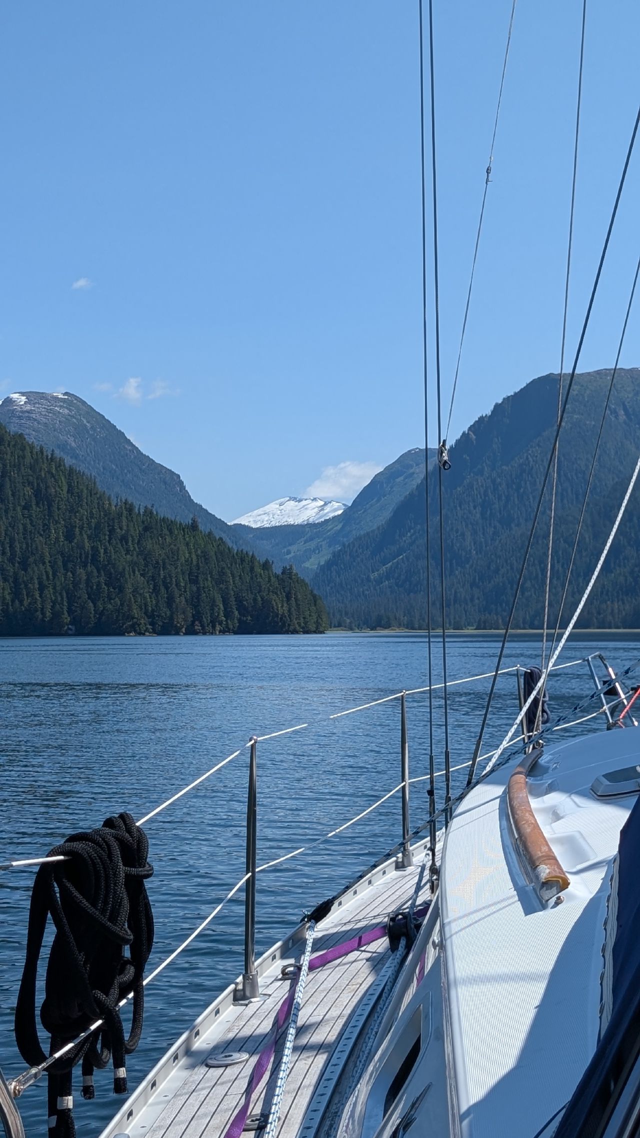 View from the deck of SV Yahara with snow-capped peaks in the distance at Khuntz Bay