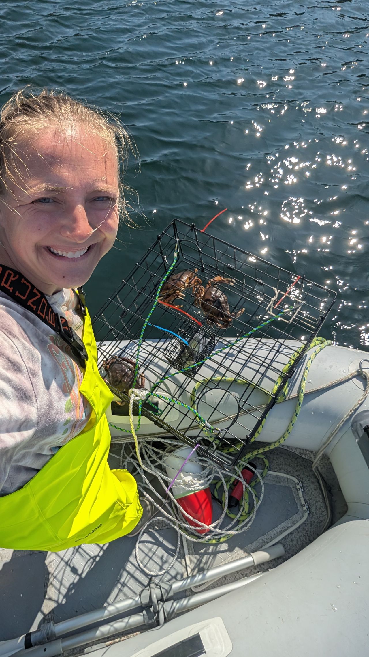 Rachel taking a selfie with a crab trap full of crabs at Barnard Harbour