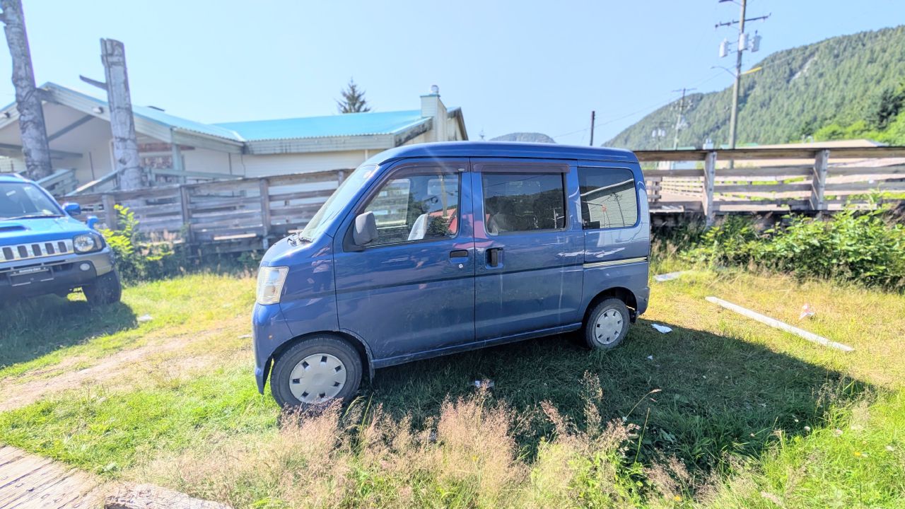 Cute blue Japanese mini van parked in Hartley Bay village