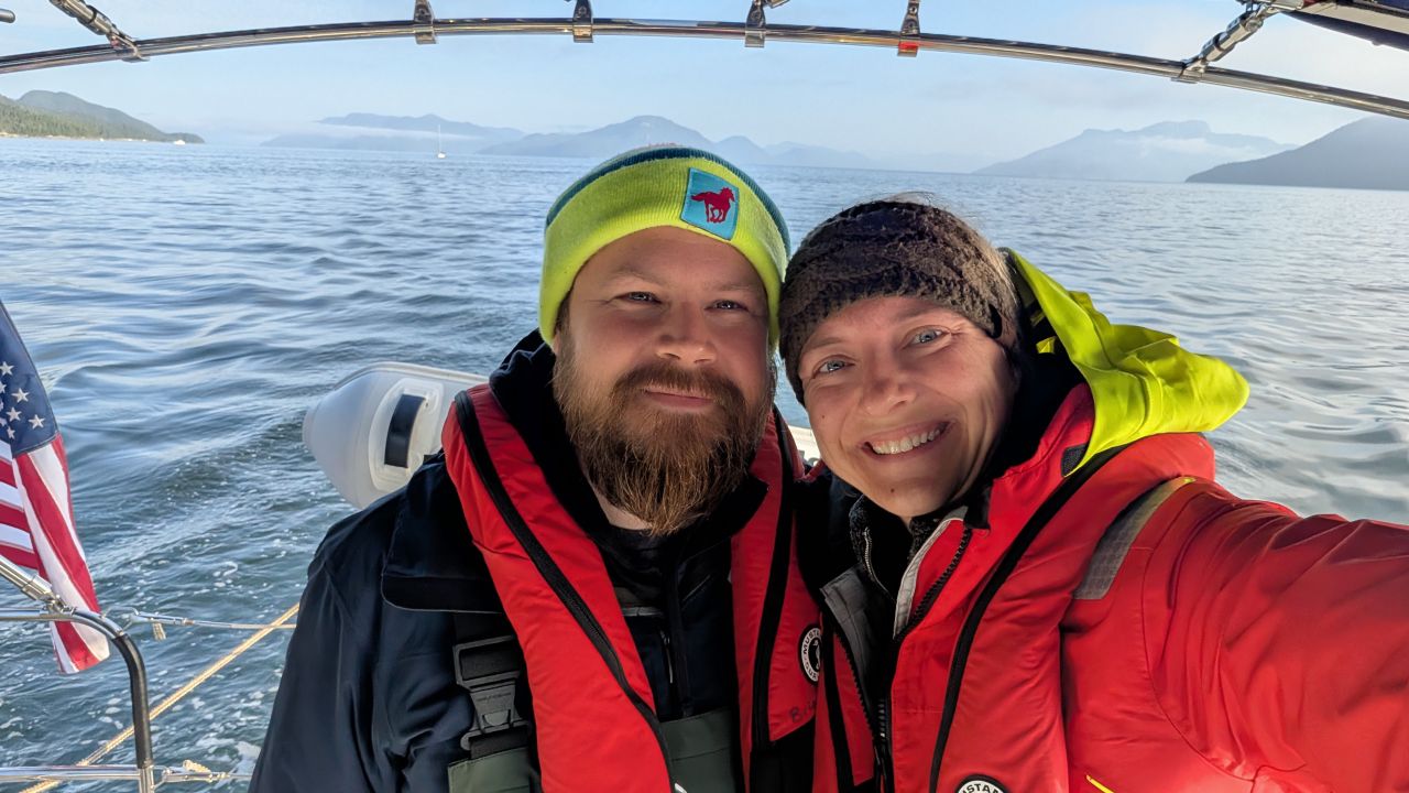 Rachel and Brian selfie in foul weather gear during the passage to Barnard Harbour