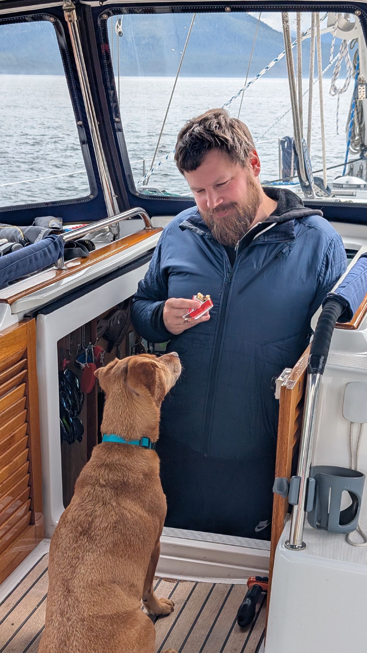 Brian giving Maui a treat in the companionway during the passage