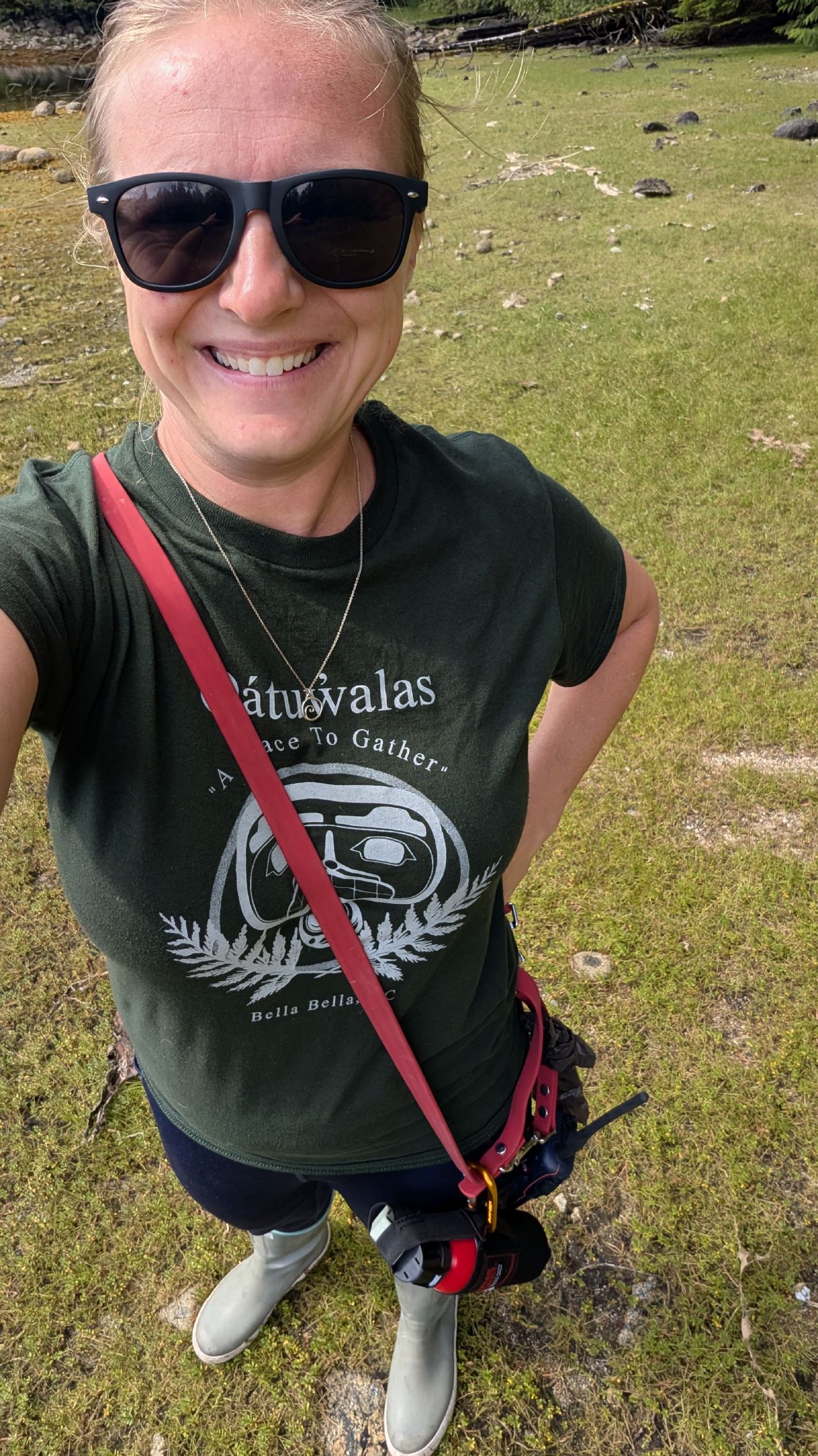 Rachel smiling in a Bella Bella souvenir t-shirt while exploring ashore at Quiggly Creek Cove