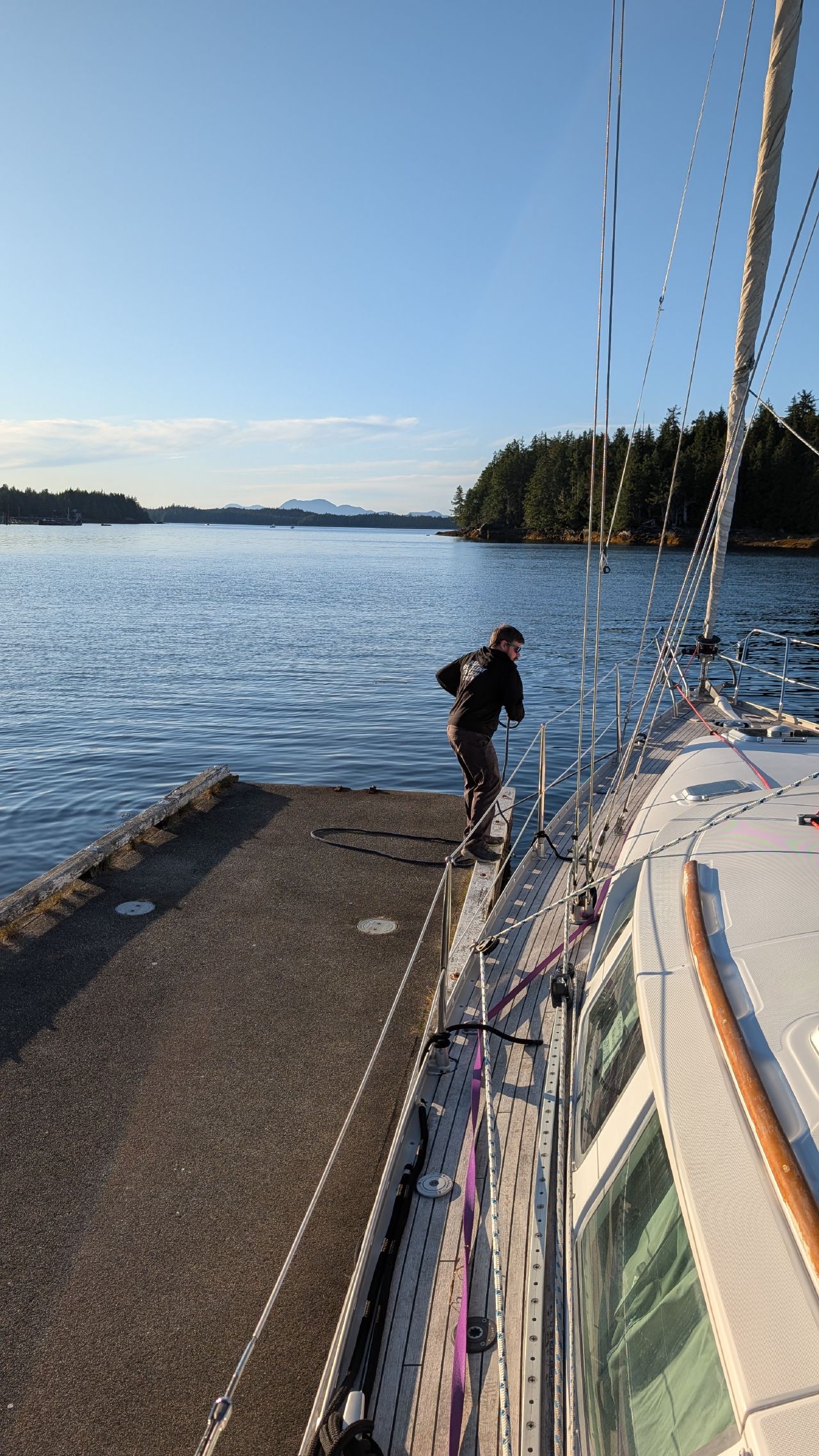 Brian stepping from SV Yahara onto the dock at Shearwater to tie up lines