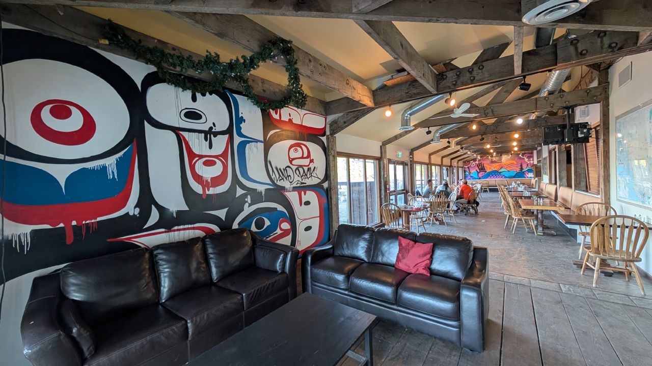 Interior of the Fisherman’s Bar and Grill at Shearwater with large First Nations mural on the wall