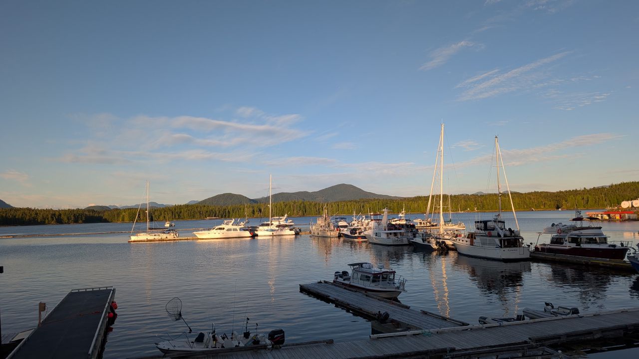 Boats docked at Shearwater Marina during golden hour with mountains in the background