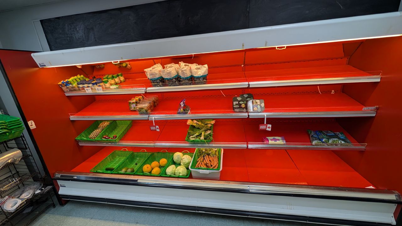 Nearly empty produce shelves at the Shearwater grocery store waiting for freight delivery