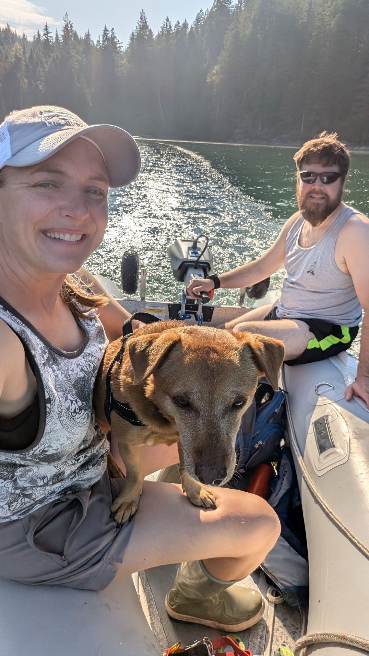 Rachel, Brian, and Maui selfie in the dinghy during golden hour at Octopus Islands