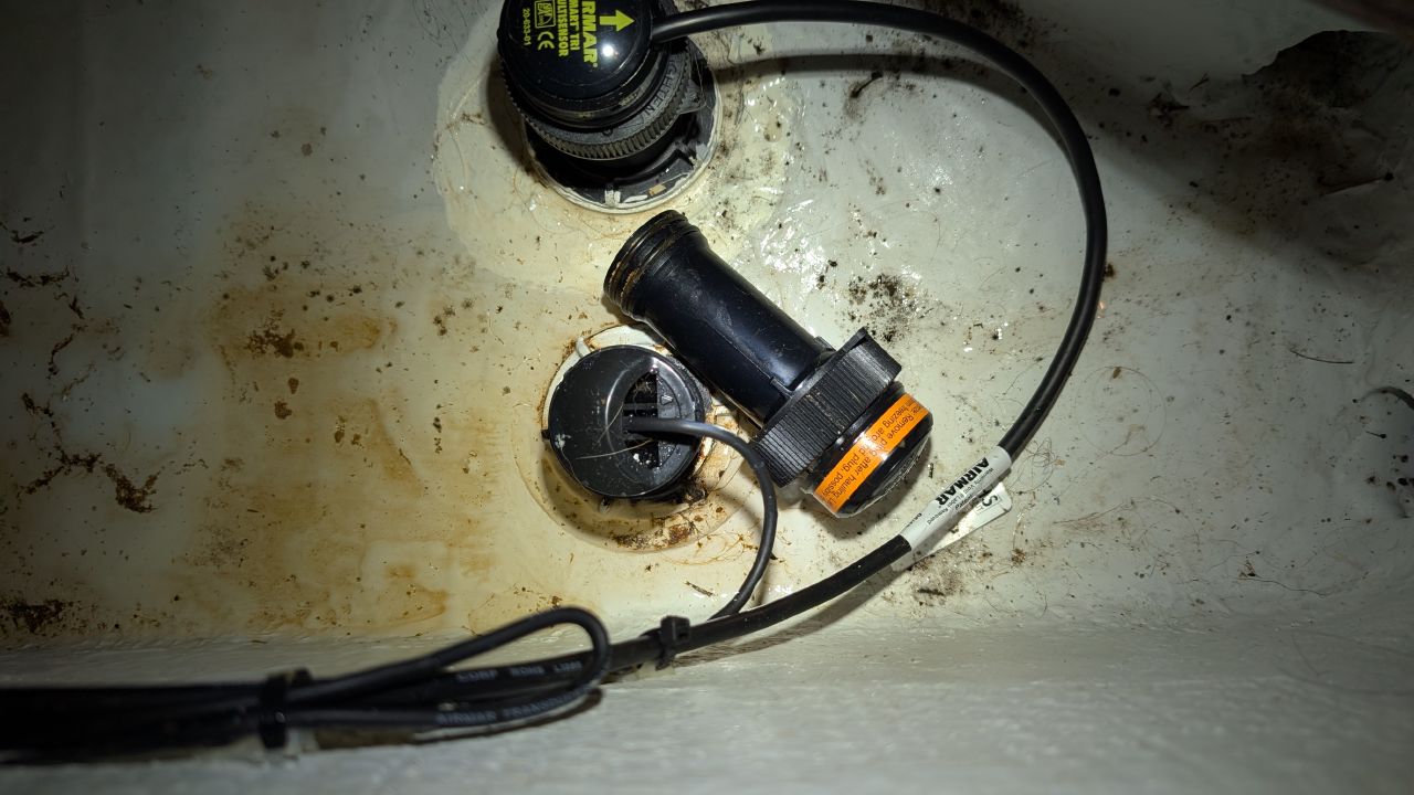 Bilge pump area with Airmar transducer and pool of fresh water from a slow leak below deck