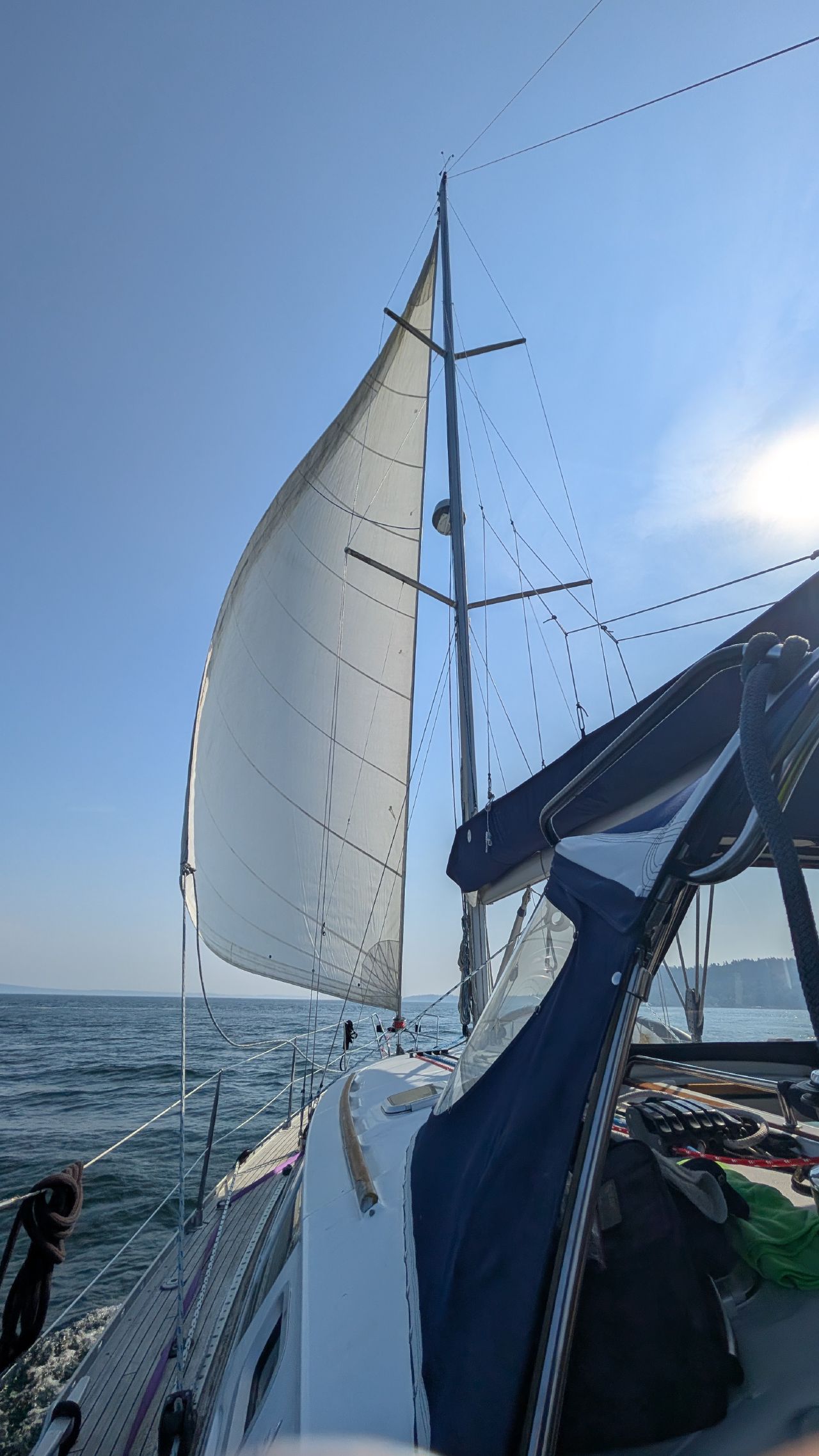 SV Yahara sailing with the jib unfurled on a sunny day in Puget Sound
