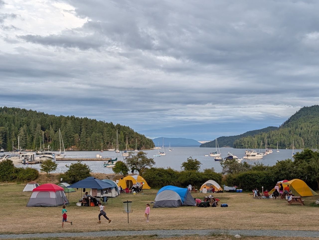Tents on the lawn above the Port Browning anchorage full of boats