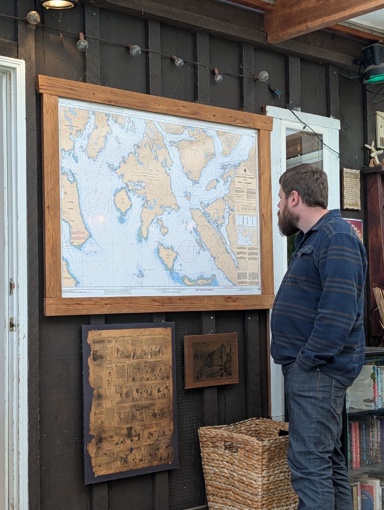 Brian studying a nautical chart of the area on the restaurant wall